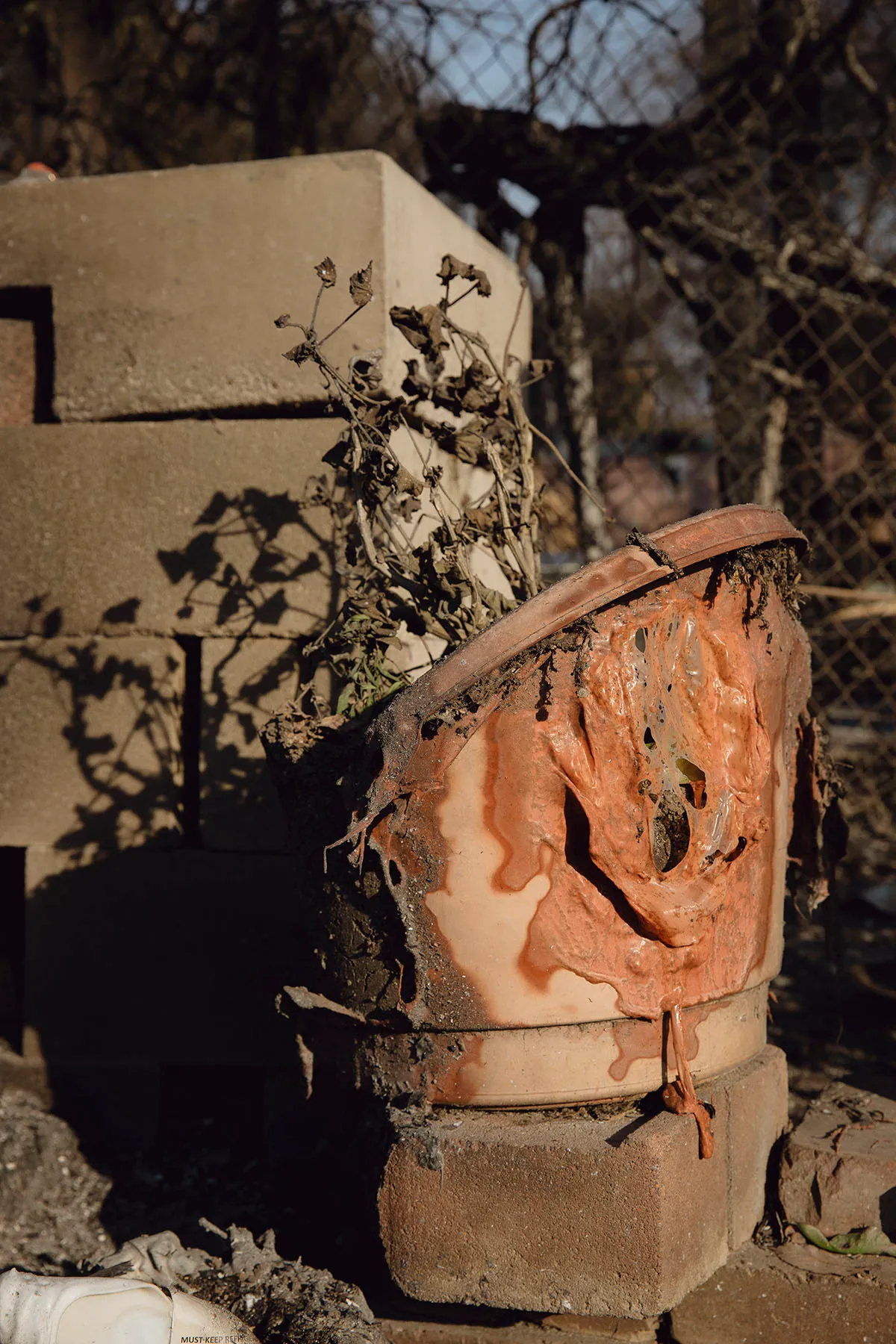 A melted flower pot in seen in the ruins of Sanchez' home.