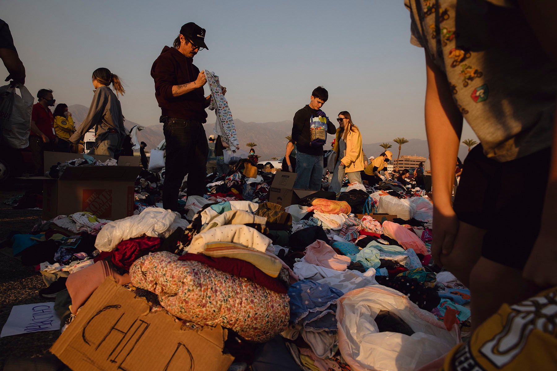 At a self-made donation center at Santa Anita Park in Arcadia, California, people sort through clothes donated to those affected by the Eaton Canyon fire.