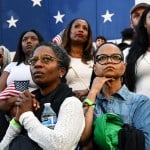 Women listen as Vice President Kamala Harris concedes the election during a speech at Howard University.