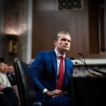 Pete Hegseth listens during a Senate Armed Services Committee confirmation hearing.