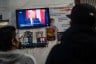 People watch the inauguration of President Trump at the Juventud 2000 shelter in Tijuana, Mexico, on January 20, 2024.