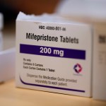 A box of Mifepristone abortion pill tablets sits on a counter.