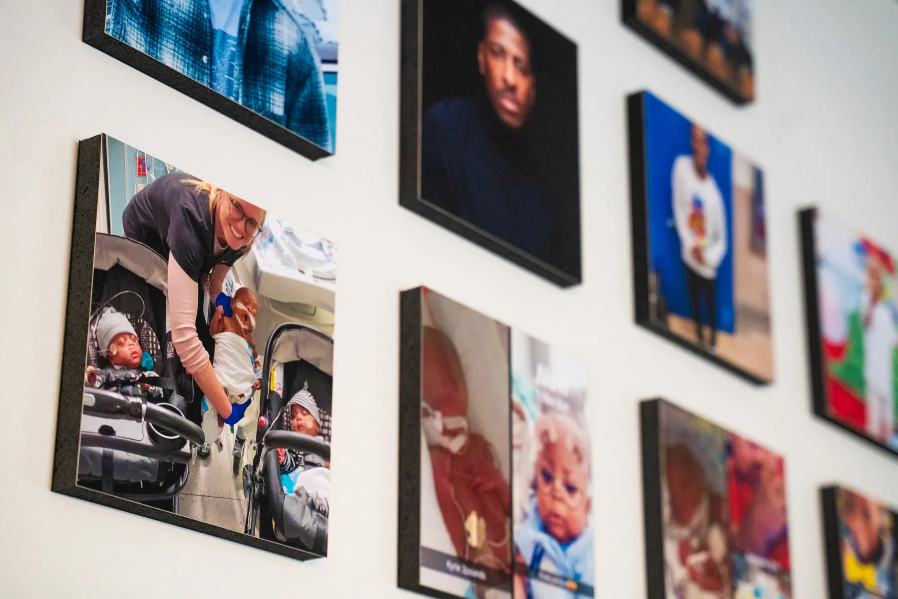 A wall of photos includes an image of the triplets as infants in the NICU with a smiling nurse holding one of them.