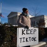 A demonstrator holds a pro-TikTok sign in front of the Supreme Court ahead of arguments on social media app TikTok.