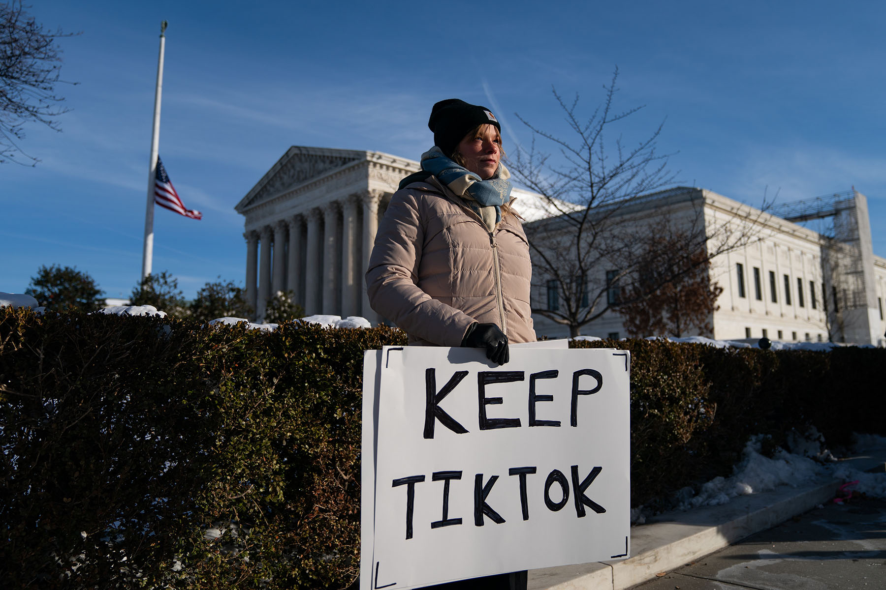 A demonstrator holds a pro-TikTok sign in front of the Supreme Court ahead of arguments on social media app TikTok.