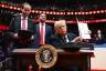 President Trump holds an executive order he just signed during the inaugural parade inside Capital One Arena.