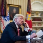 President Trump speaks on the phone in the oval office of the White House.