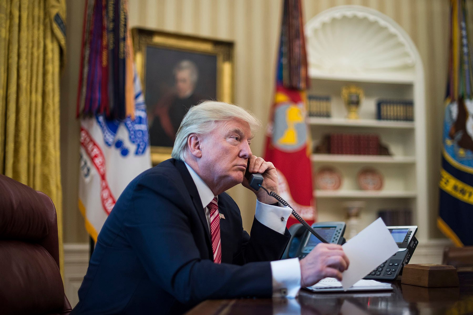 President Trump speaks on the phone in the oval office of the White House.