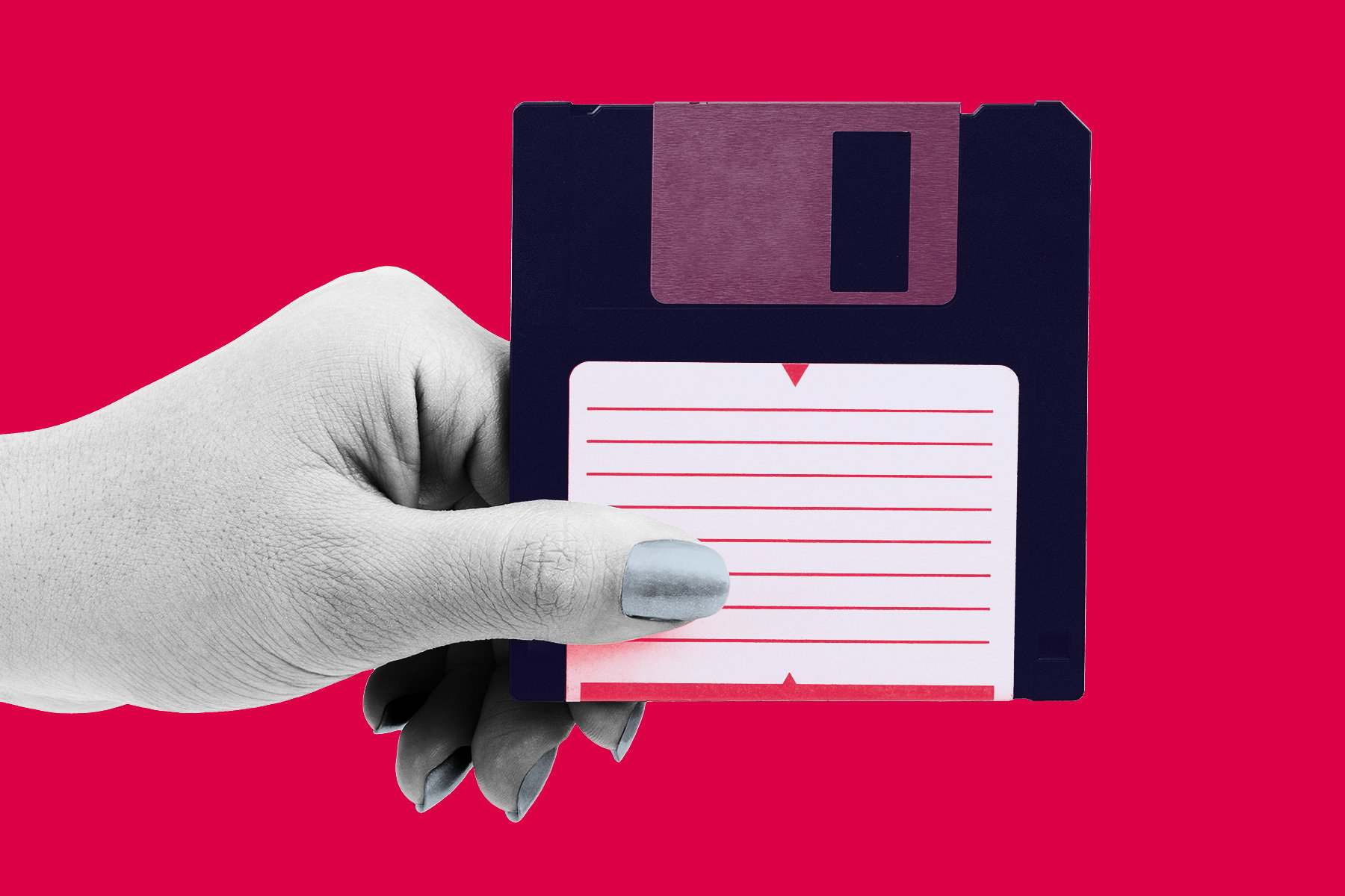 A hand holding a floppy disk.