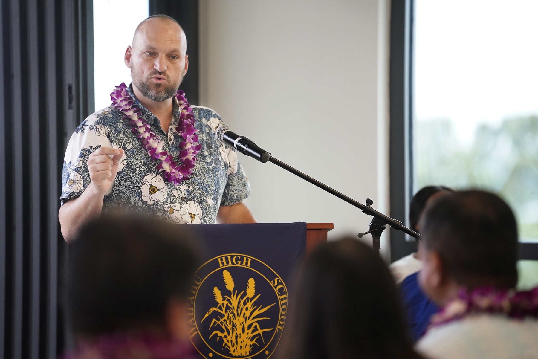 Waipahu High School Principal Zachary Sheets stands at a podium.