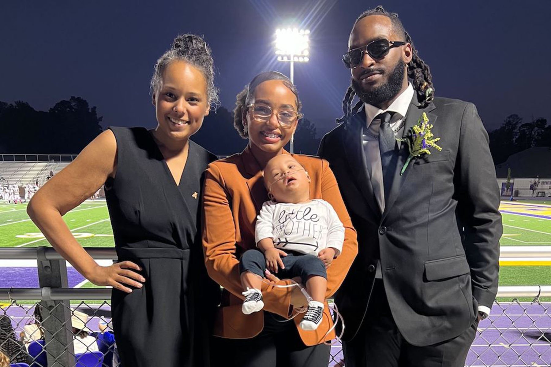 Charlotte Cravins, left, attends an event with her husband, Calvin Bell, and their children, infant son Landry Bell and daughter Lyric Bell.