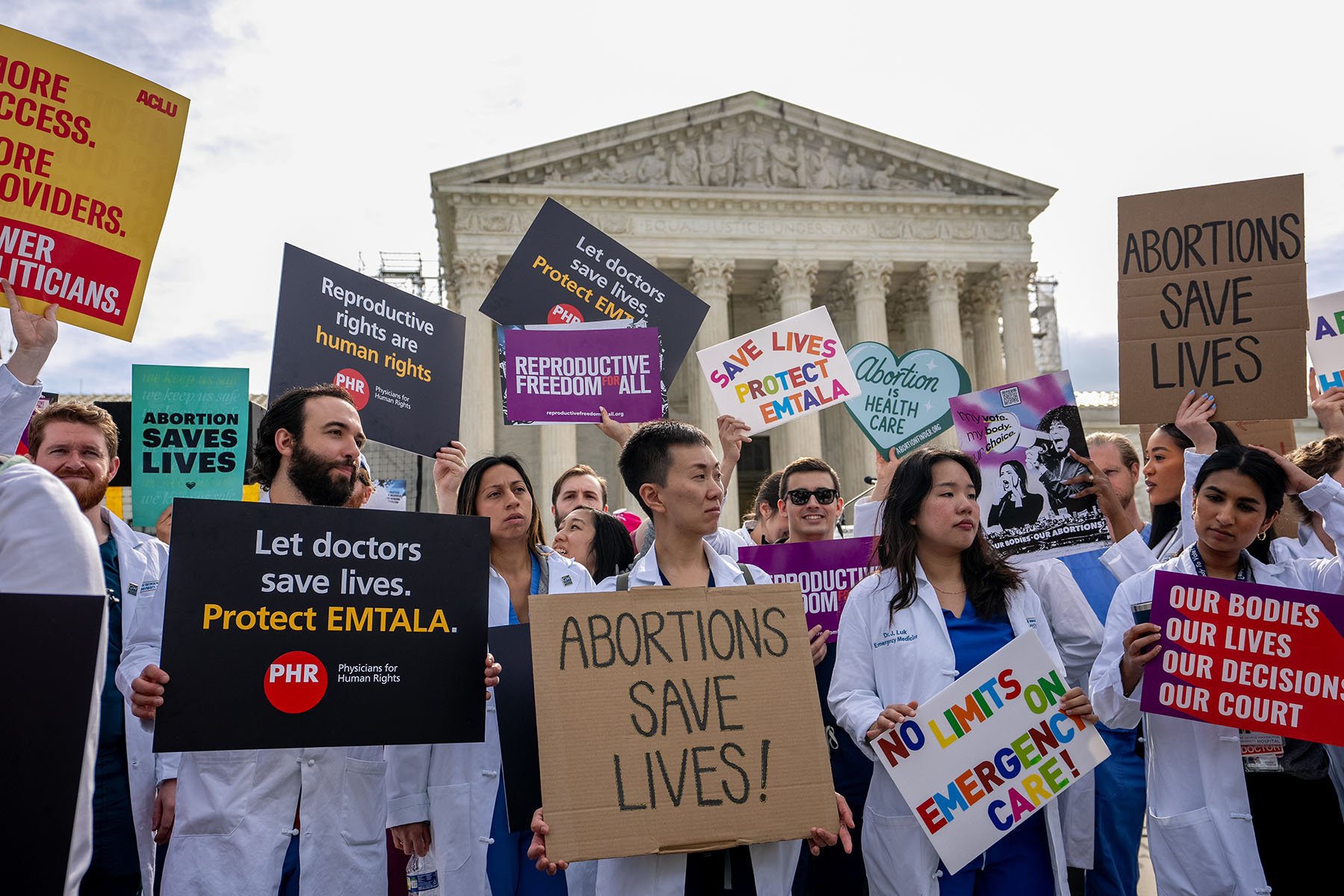 A group of doctors join abortion rights supporters at a rally outside the Supreme Court.