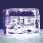 A purple block of ice with a 100 dollar bill frozen into it.