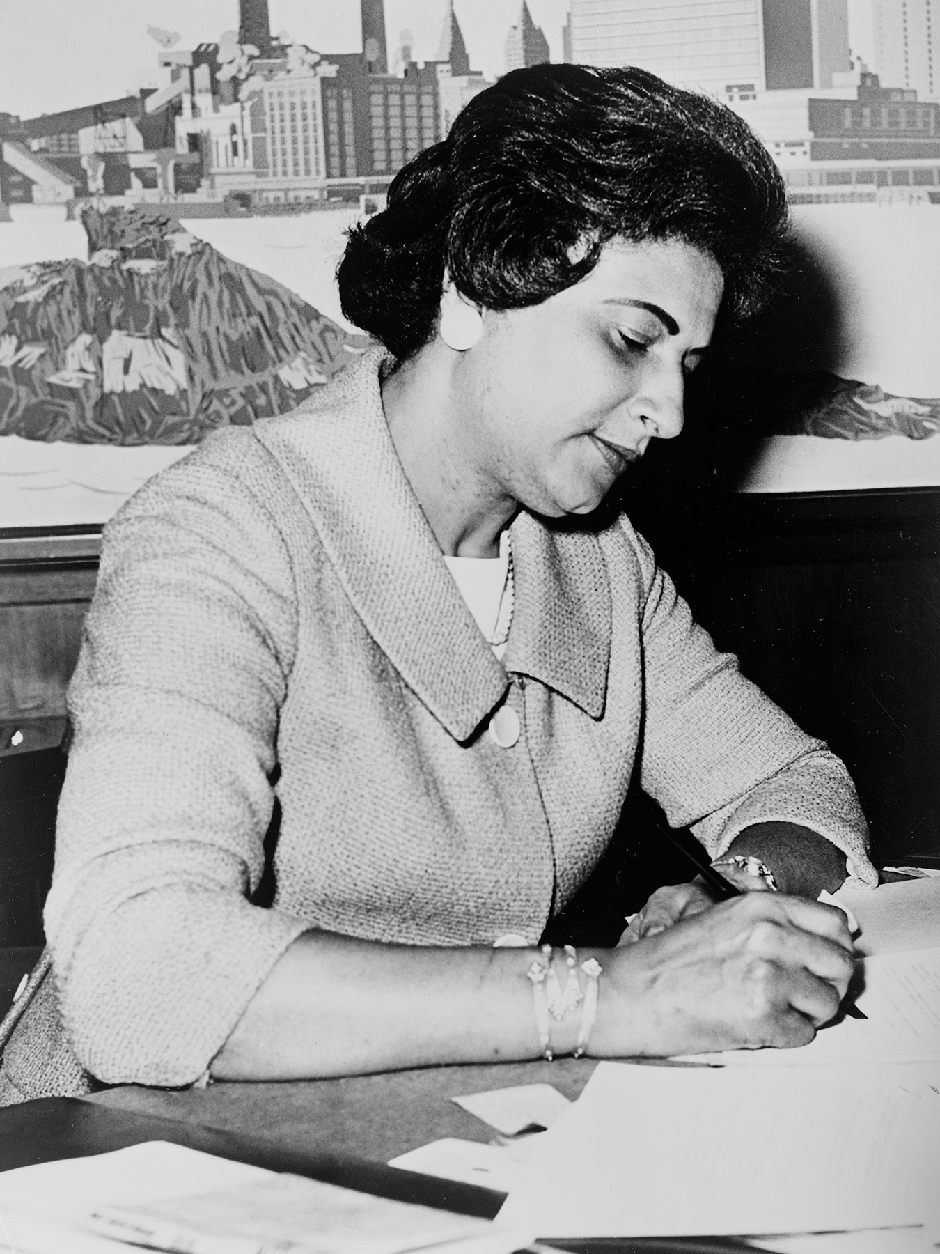 Constance B. Motley signs documents in 1965