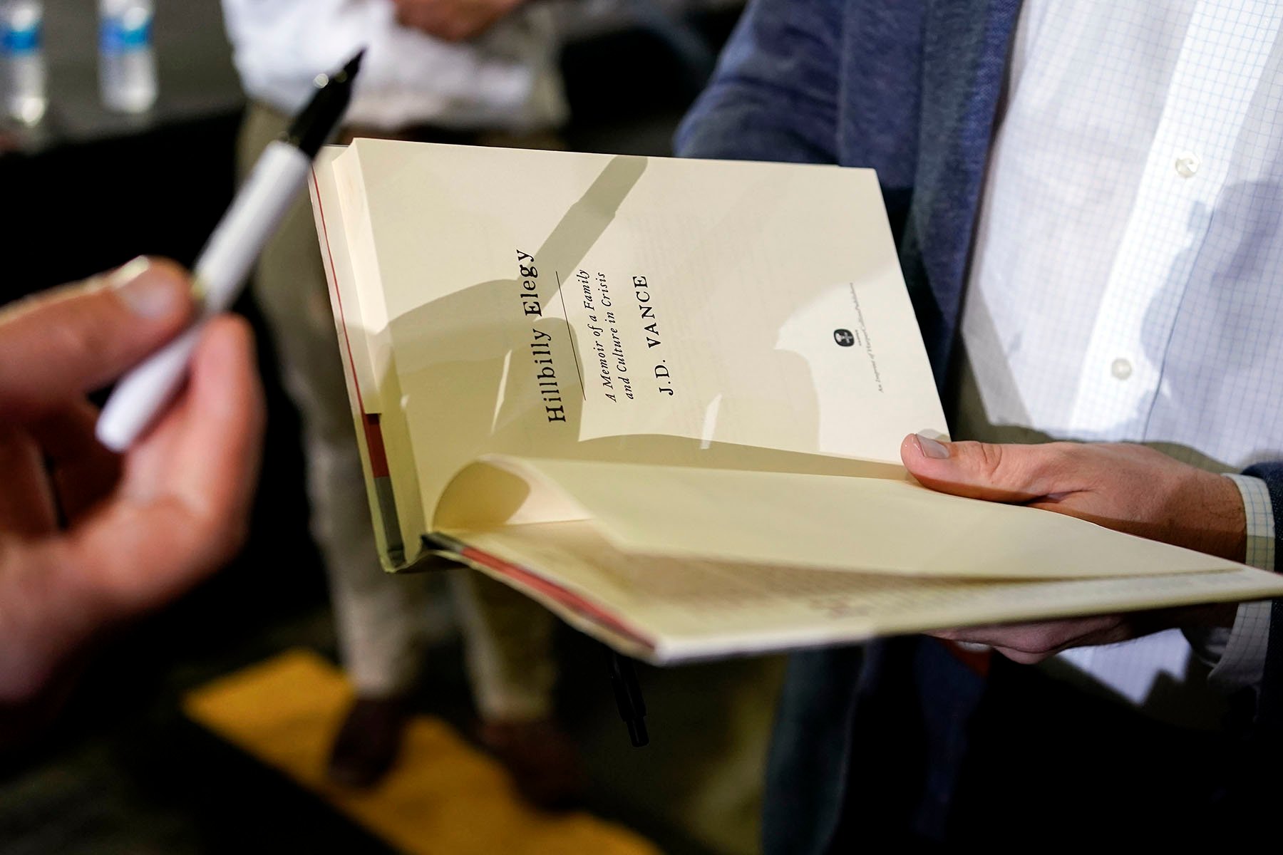 JD Vance autographs his book after a rally in Middletown, Ohio.