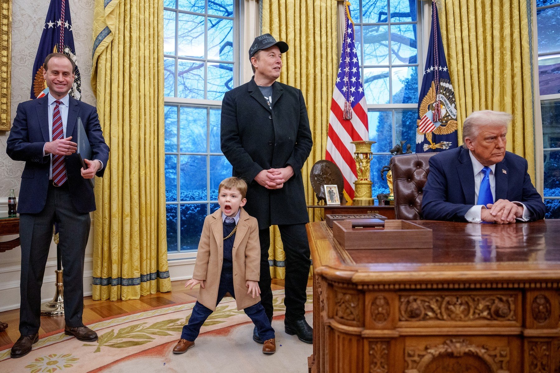 White House staff secretary Will Scharf, Tesla and SpaceX CEO Elon Musk, joined by his son X Musk, and U.S. President Donald Trump appear for an executive order signing in the Oval Office.