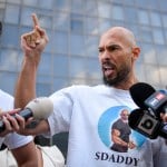 A man points angrily in front of cameras.