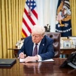 President Trump signs executive orders in the Oval Office at the White House.