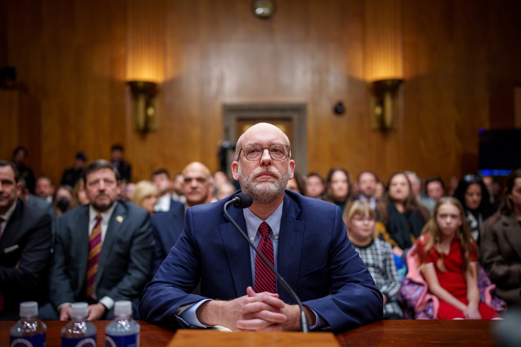 Russell Vought sits at a confirmation hearing.