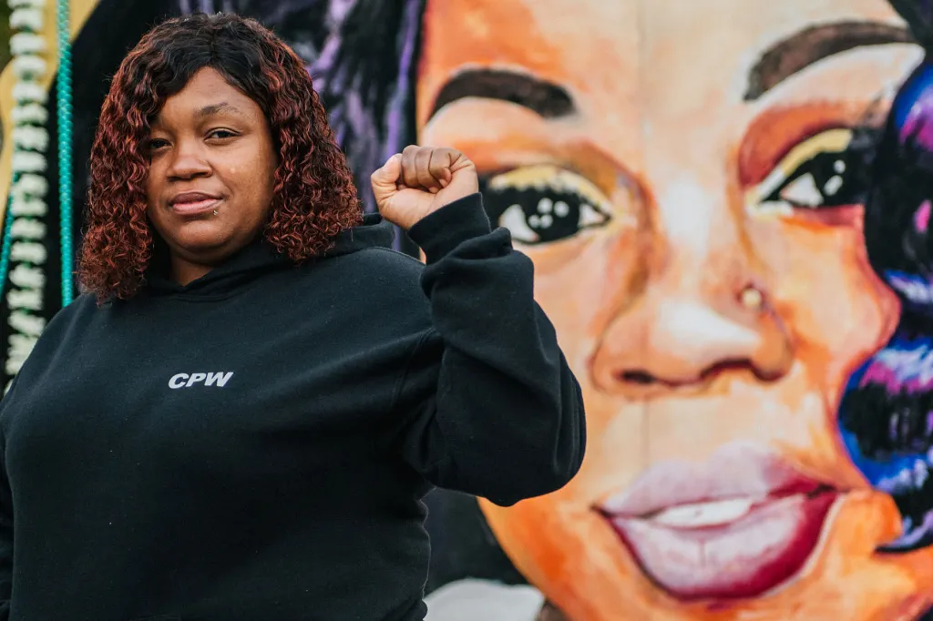 Tamika Palmer, mother of Breonna Taylor, poses for a portrait in front of a mural of her daughter at Jefferson Square park in Louisville, Kentucky.