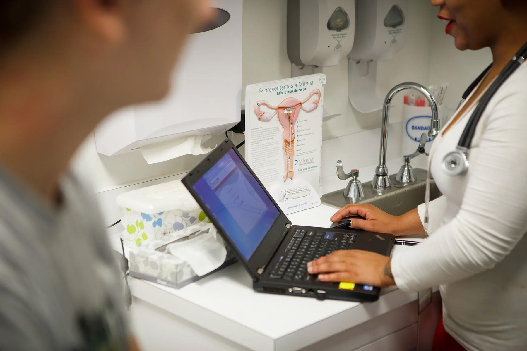 A nurse speaks with a patient at a clinic in Houston, Texas.