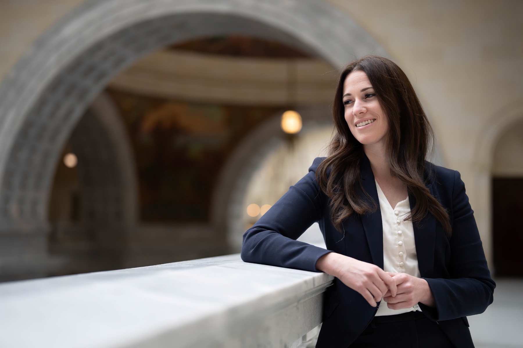Stephanie Pitcher leans against a railing in the Utah Capitol.