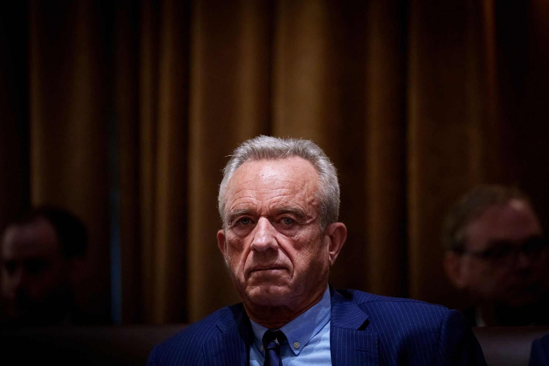 An image of HHS Secretary Robert F. Kennedy Jr., seated and wearing a blue suit at a Cabinet meeting.