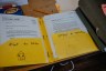Yellow folder with Spanish labels contains Yessenia Ruano’s immigration paperwork on a desk, with documents from Lisinski Law visible.