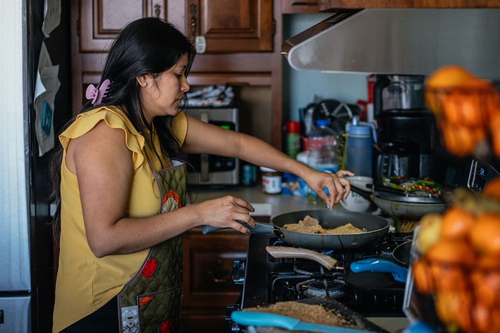 Ruano cooks in her kitchen, making lunch for her daughters.