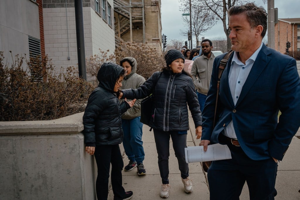 Ruano and her attorney walk toward the ICE building with her daughters.