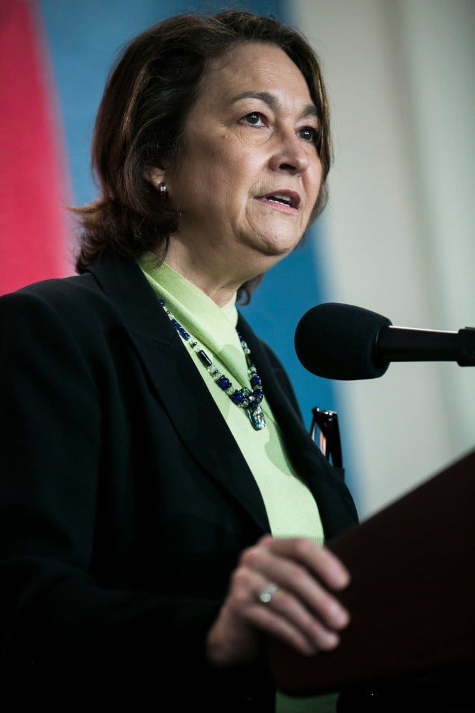 A woman speaks at a podium.