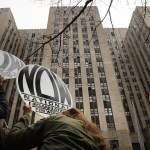 Women hold signs saying 