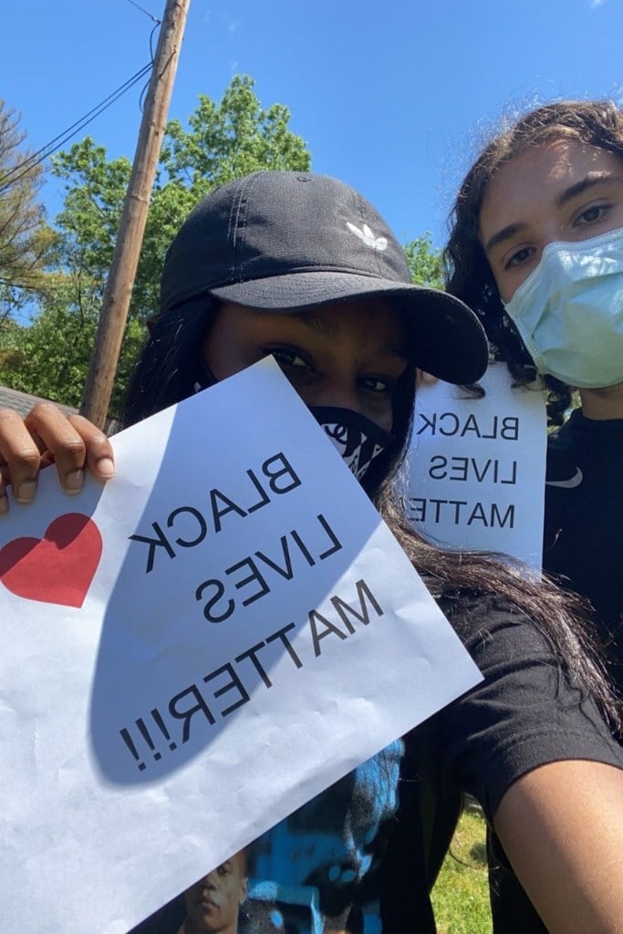 Two people hold up signs.