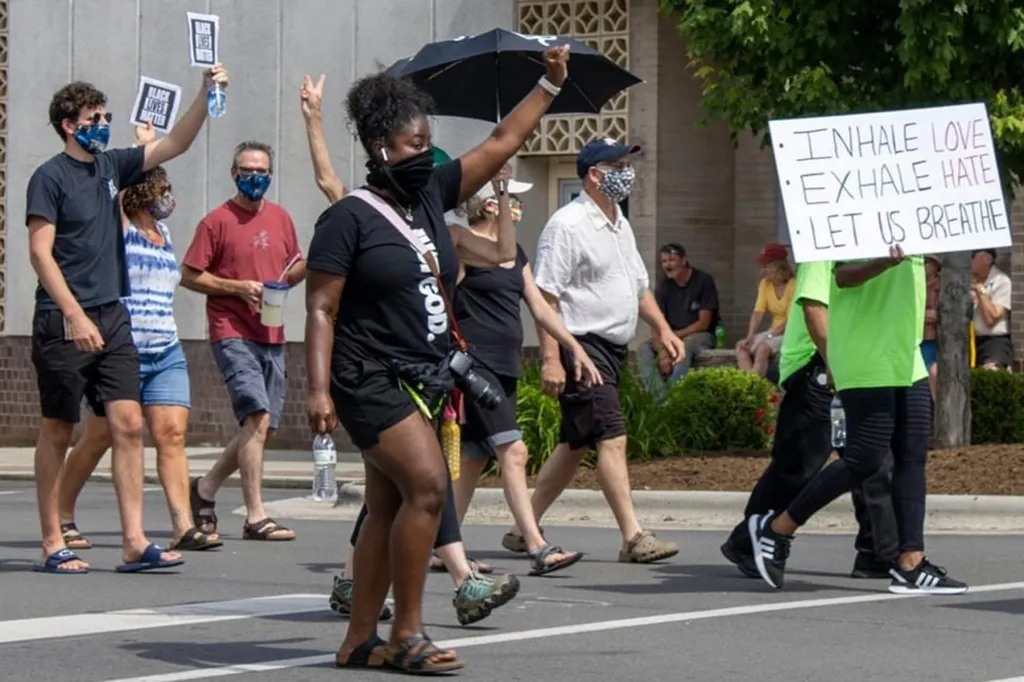 Protestors march up the street.