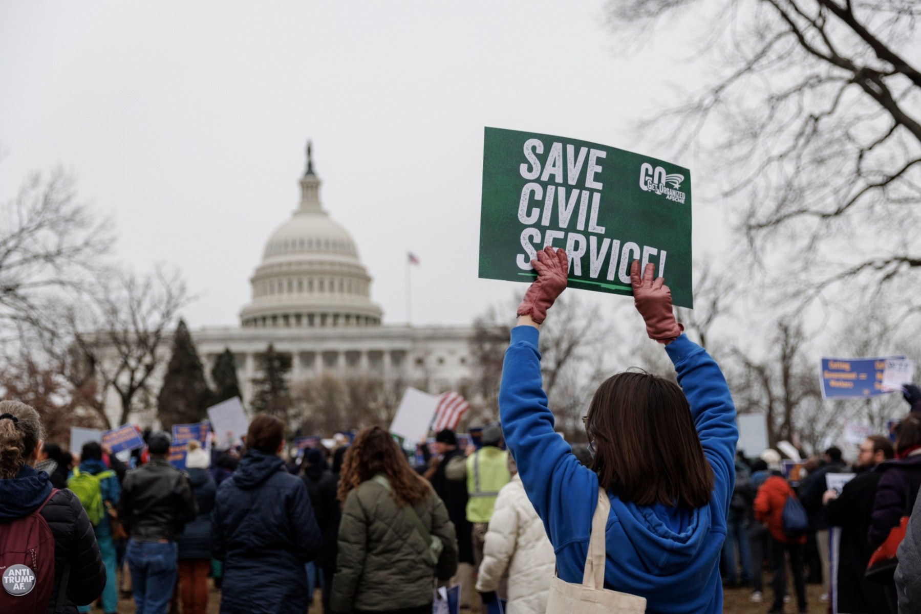 Federal workers hold signs in a rally at Upper Senate Park in Washington, D.C.