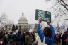 Federal workers hold signs in a rally at Upper Senate Park in Washington, D.C.