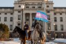 Two protestors on horseback in front of the South Dakota capitol building.