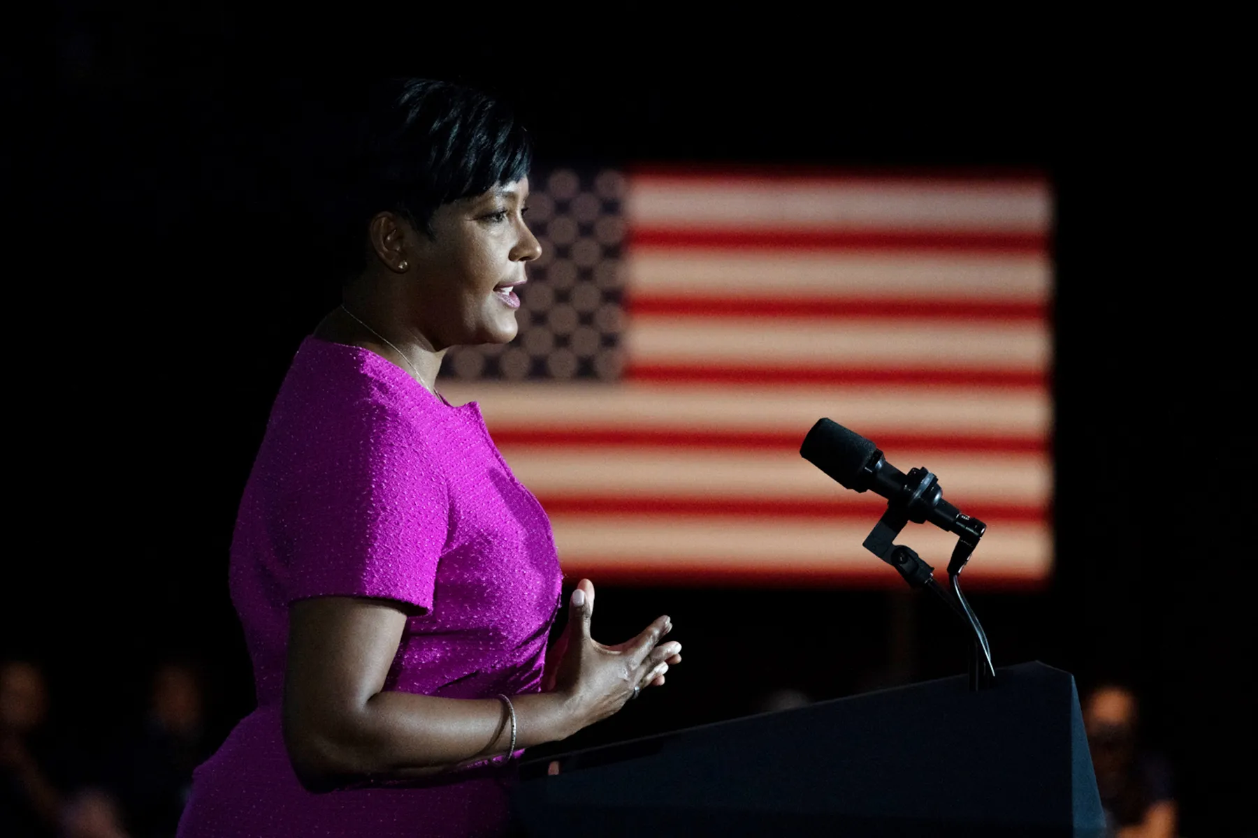 Keisha Lance Bottoms stands at a podium in front of an American flag.