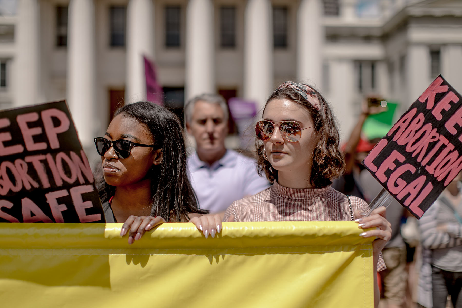 Two people hold signs reading “Keep abortion safe” and “Keep abortion legal” during a 2019 protest in Missouri, when the state’s last abortion clinic was at risk of closing.