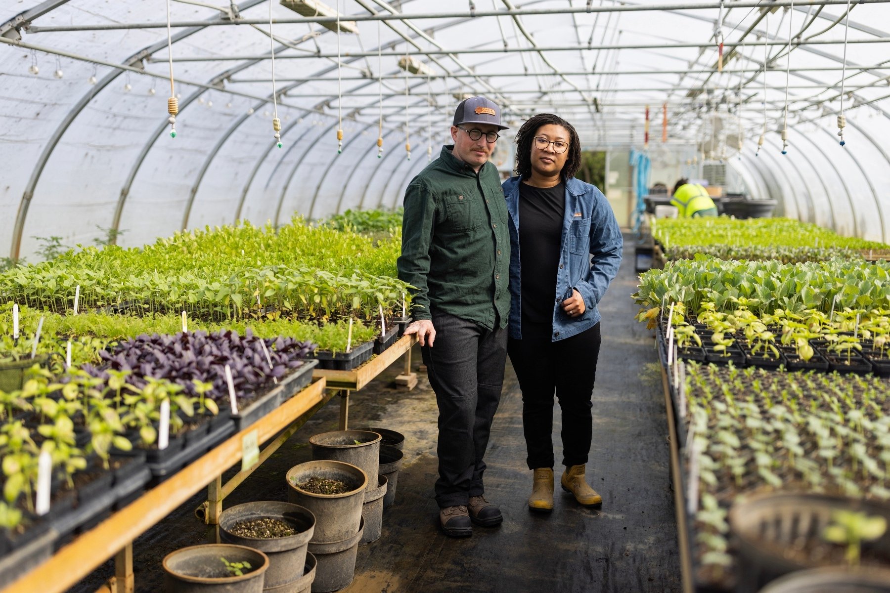 Two people stand for a portrait on their farm.