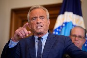 Health and Human Services Secretary Robert F. Kennedy Jr. speaks while pointing his finger wearing a blue suit with stripes on it.