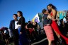 People dance and laugh together at an outdoor day party.