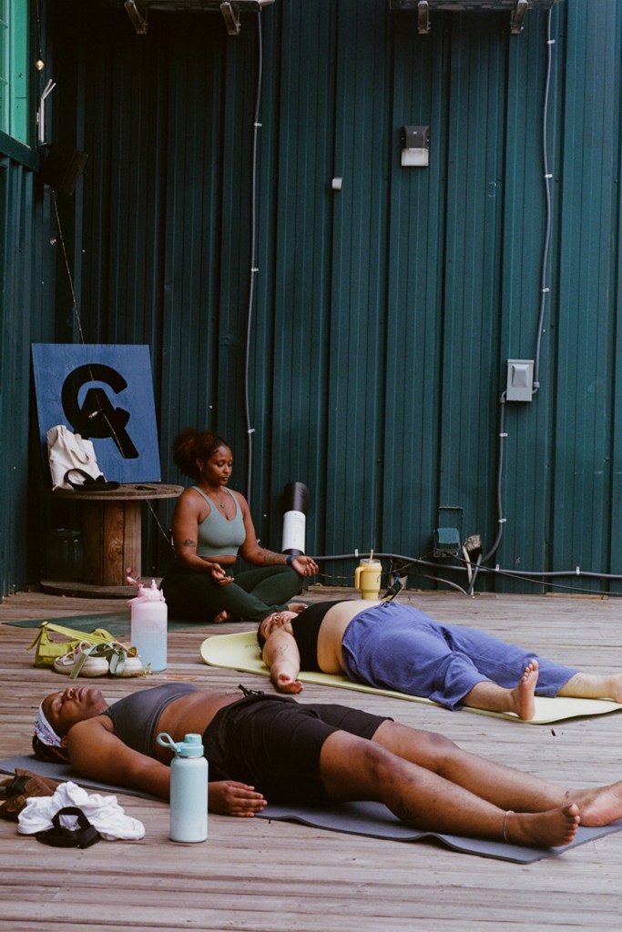 Several people lay on yoga mats on the floor.