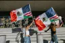 Protesters wave flags in front of members of the California National Guard in Los Angeles.