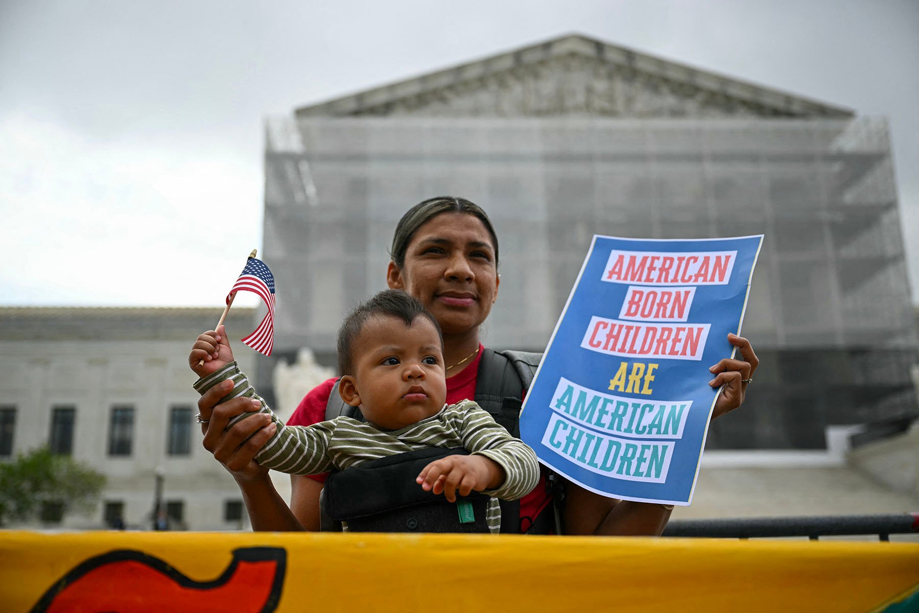 People participate in a protest outside the Supreme Court over President Donald Trump's move to end birthright citizenship as the court hears arguments over the order.