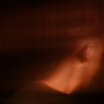 Abstract image of a man with his face turned away from the camera.