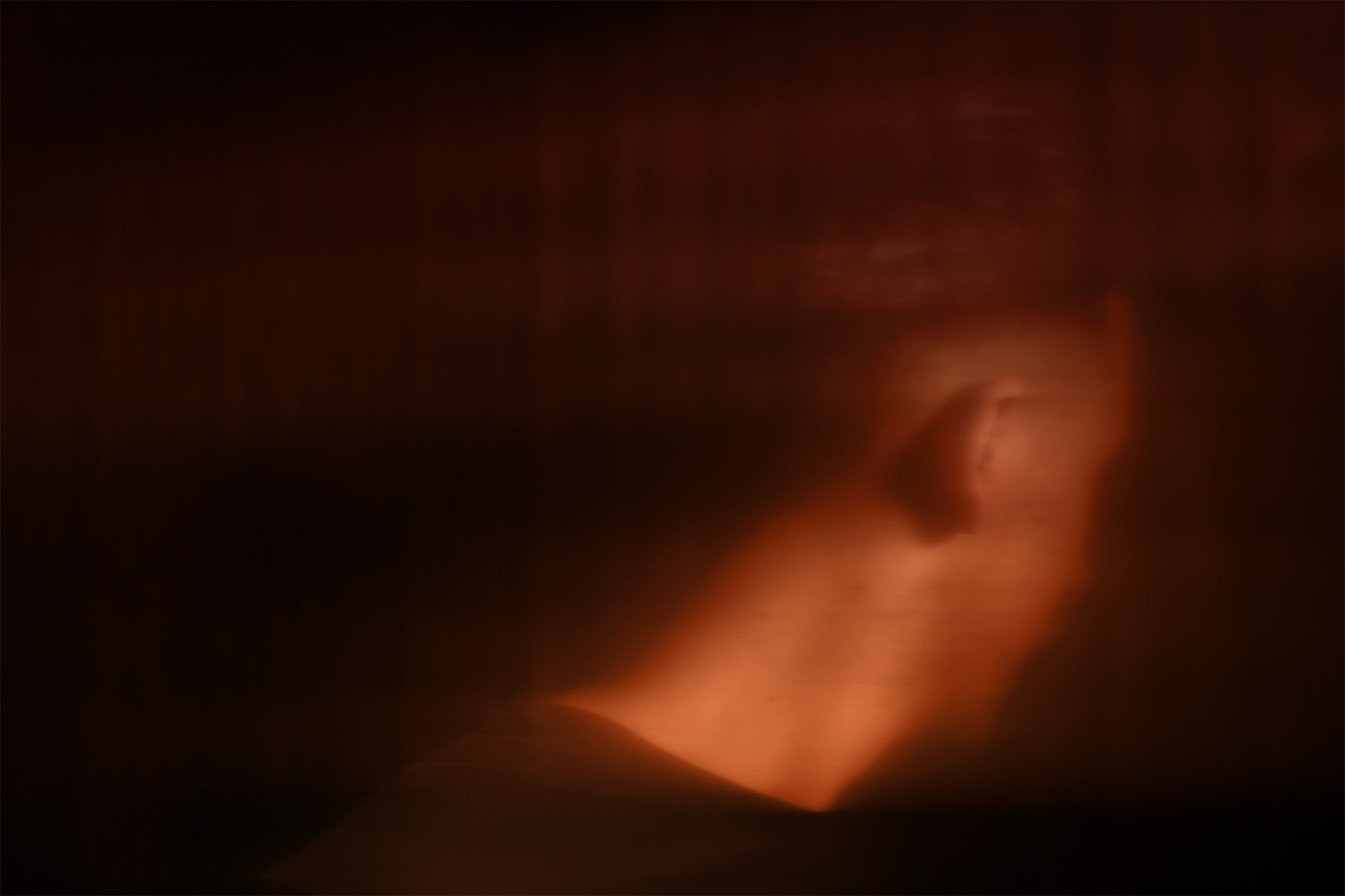 Abstract image of a man with his face turned away from the camera.
