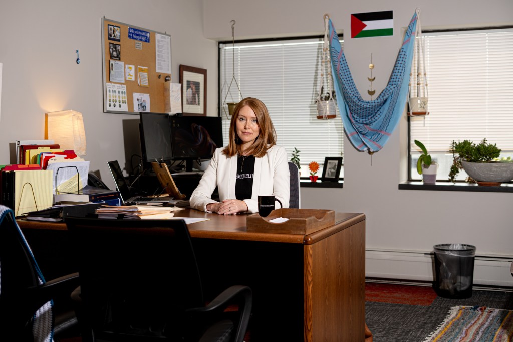 Amanda Bashi sits at her desk.