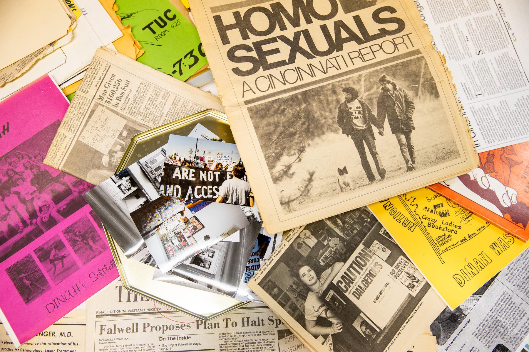 A display of archival photos, fliers and newspapers spread out.