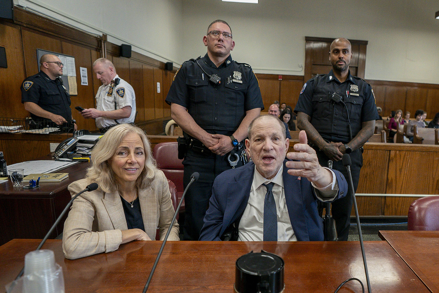 Former film producer Harvey Weinstein gestures as he sits next to attorney Diana Fabi Samson as the jury deliberates at Manhattan Criminal Court